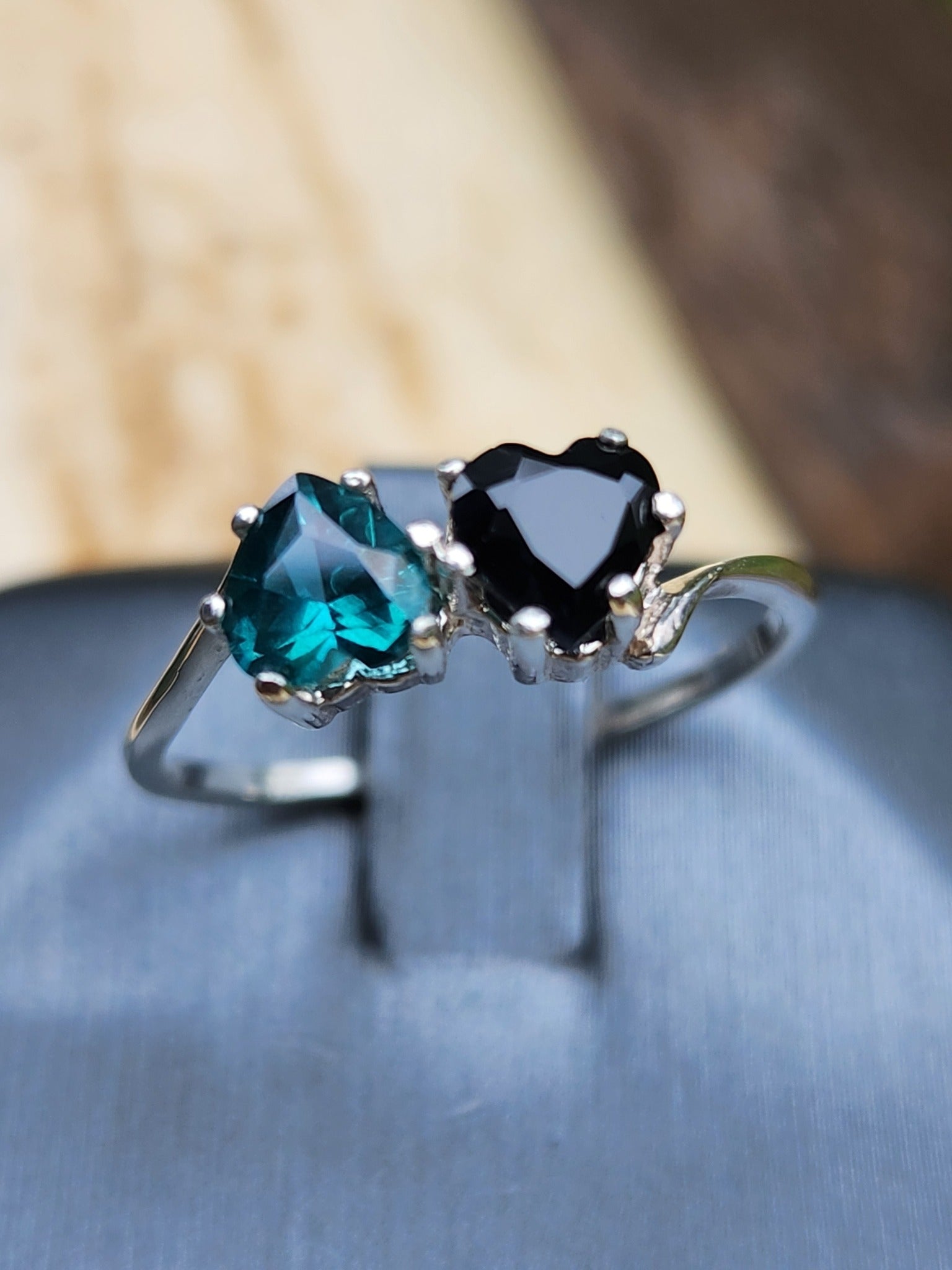 Black Sapphire and teal Topaz hearts size 7.5 in silver.