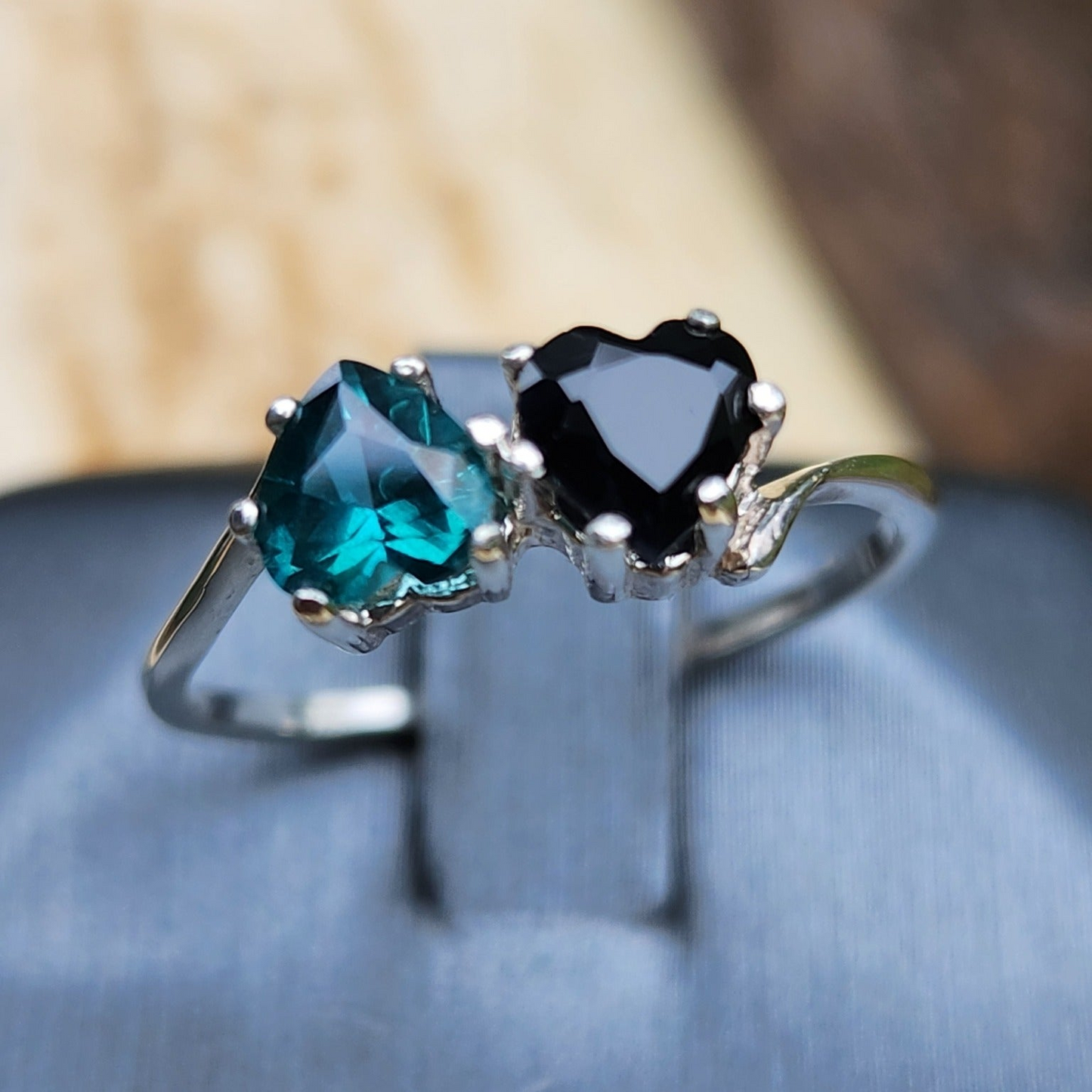 Black Sapphire and teal Topaz hearts size 7.5 in silver.