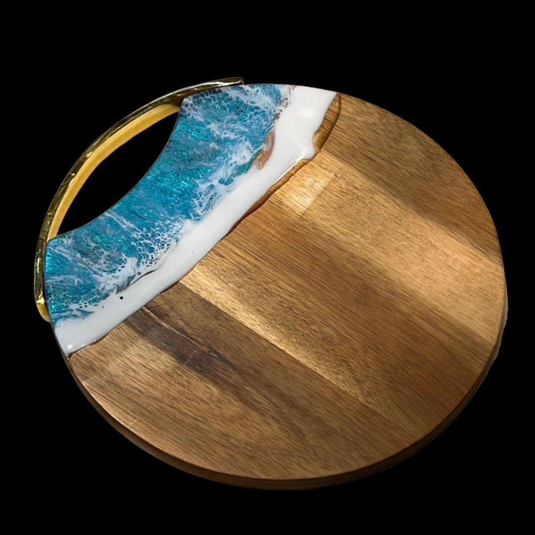 Round wooden cheese board with "Ocean" resin finish.