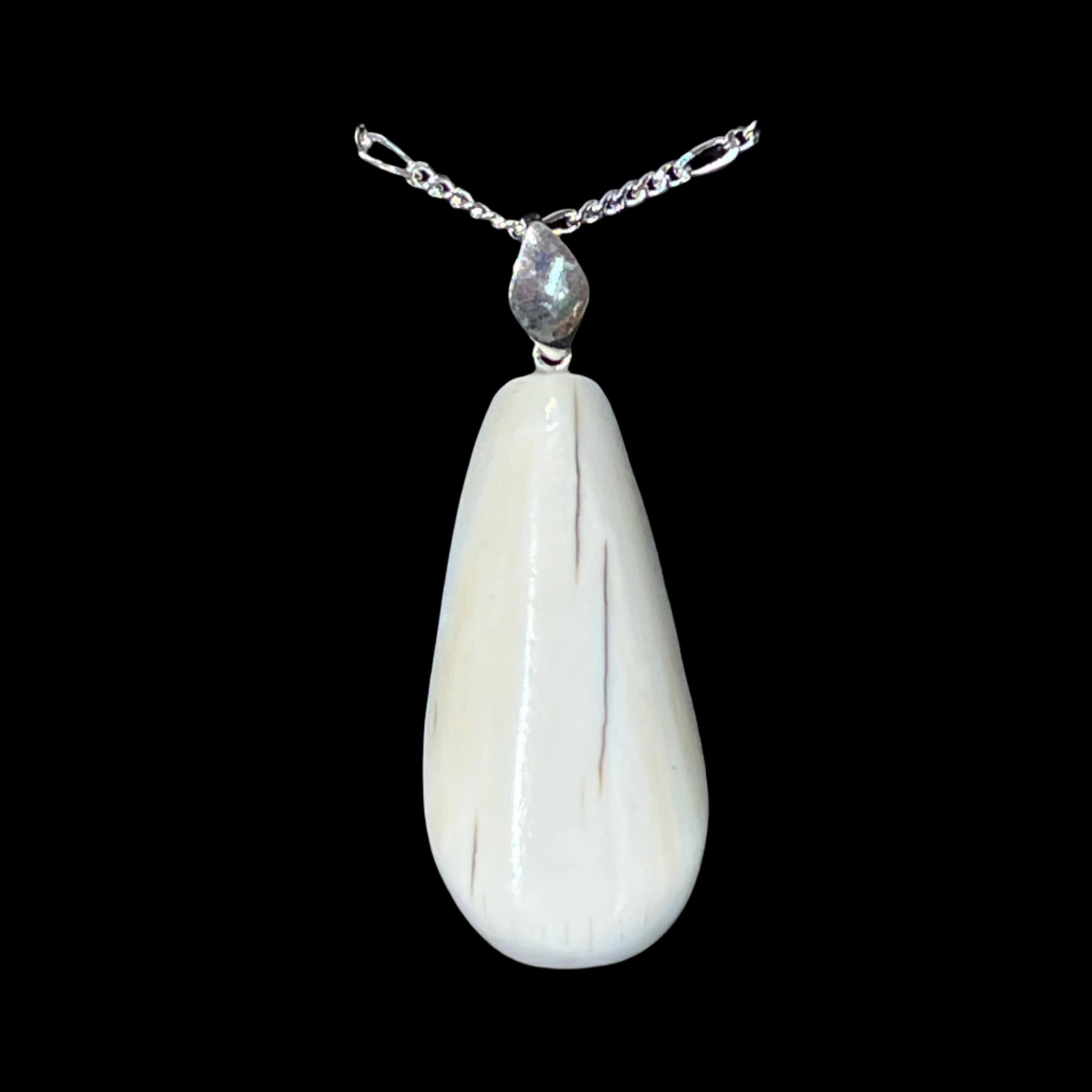 Walrus Ivory flat pear Pendant in silver. Certified Made in Alaska. This unique piece of jewelry is authentic Alaska Native art created by an enrolled member of an Alaska Native tribe.