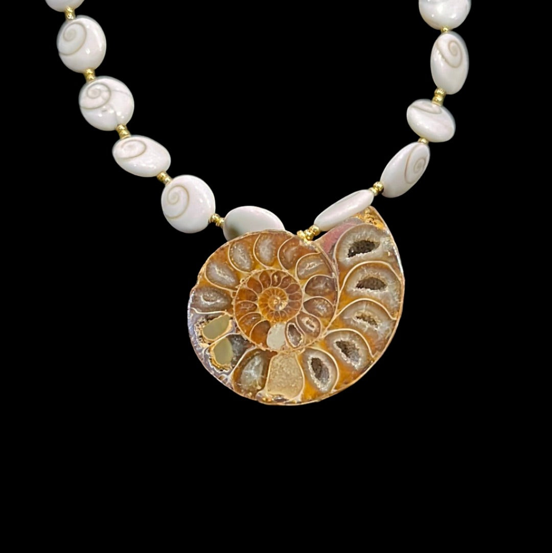 23in Ammonite Pendant Necklace 24kgol/beads spacing polished operculum (snail trap doors) showcasing an opalized Alaskan ammonite.&nbsp;