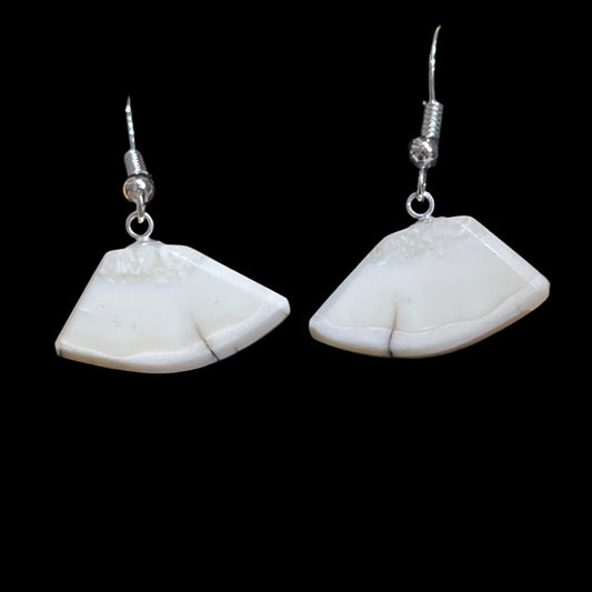 Alaskan Walrus Ivory earrings cut in a classic Alaskan ulu shape, in sterling silver. This unique piece of jewelry is authentic Alaska Native art created by an enrolled member of an Alaska Native tribe. Certified Silver Hand and Made in Alaska jewelry.