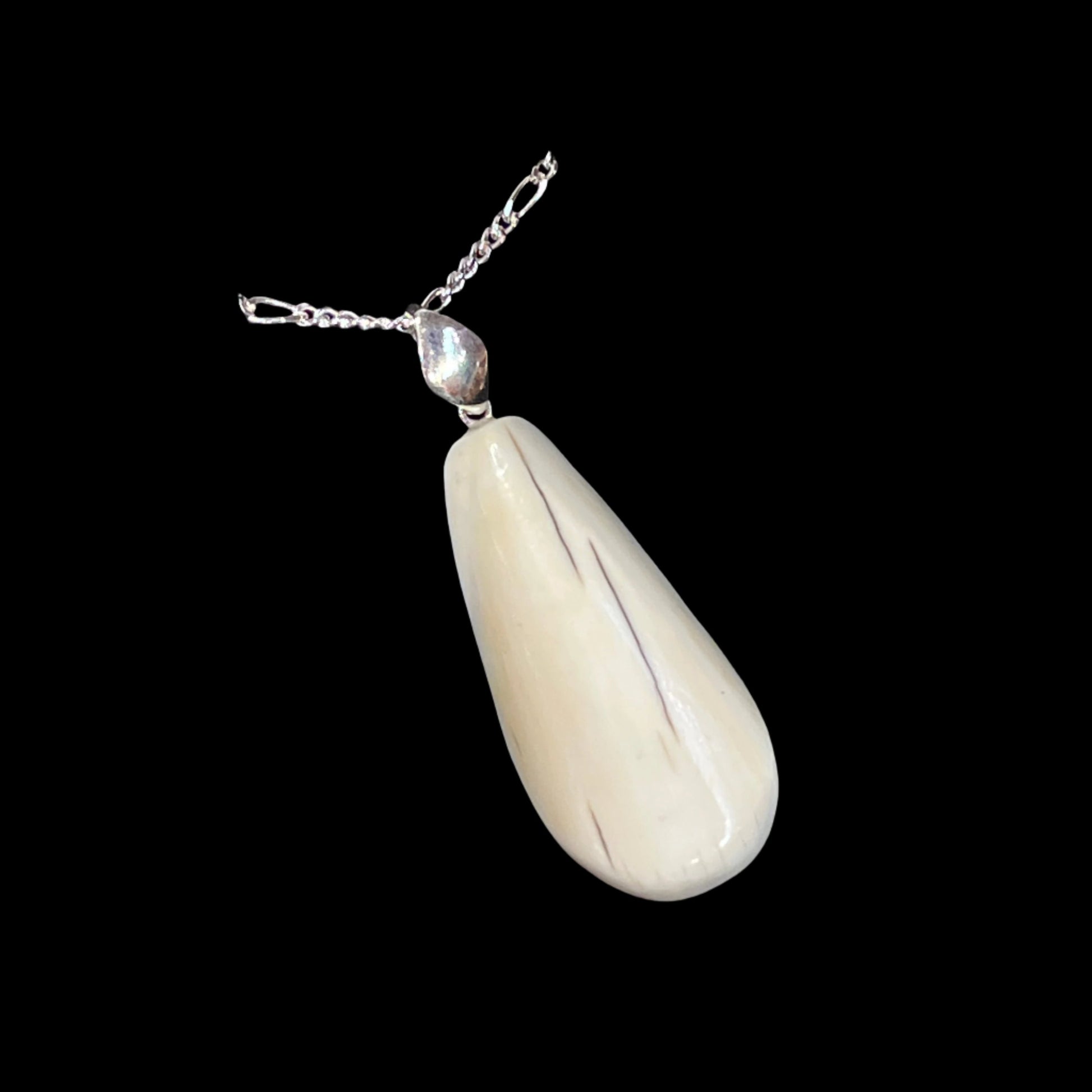 Walrus Ivory flat pear Pendant in silver. Certified Made in Alaska. This unique piece of jewelry is authentic Alaska Native art created by an enrolled member of an Alaska Native tribe.