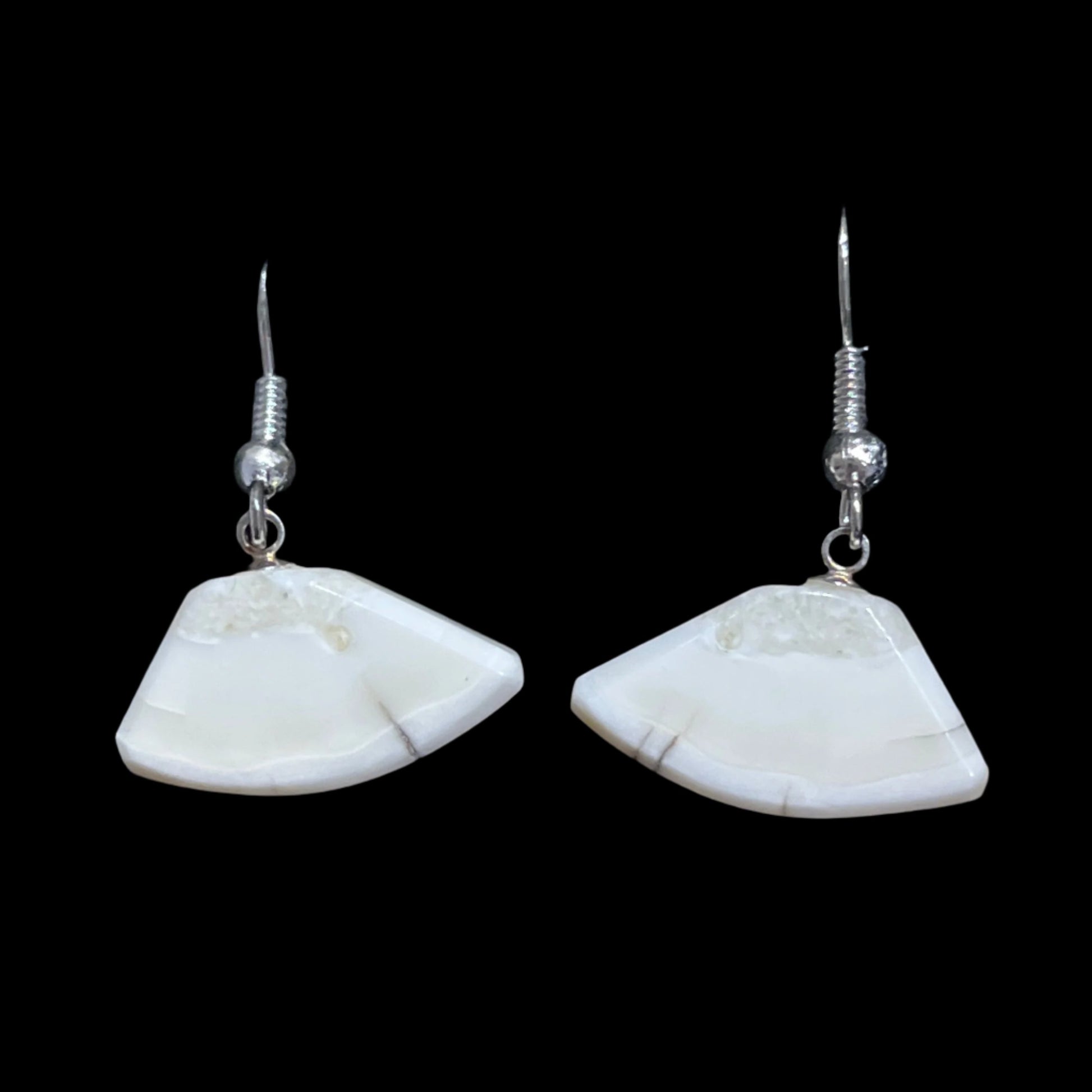 Alaskan Walrus Ivory earrings in a classic ulu shape in sterling silver. This unique piece of jewelry is authentic Alaska Native art created by an enrolled member of an Alaska Native tribe. Certified Silver Hand and Made in Alaska jewelry.