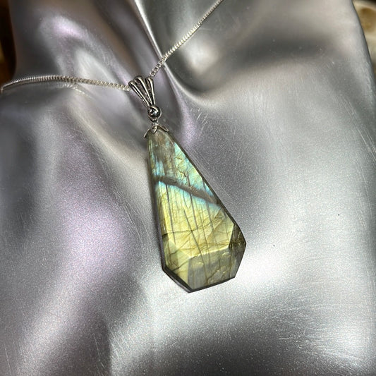 Modified teardrop labradorite pendant in silver. This unique piece of jewelry is authentic Alaska Native art created by an enrolled member of an Alaska Native tribe. 