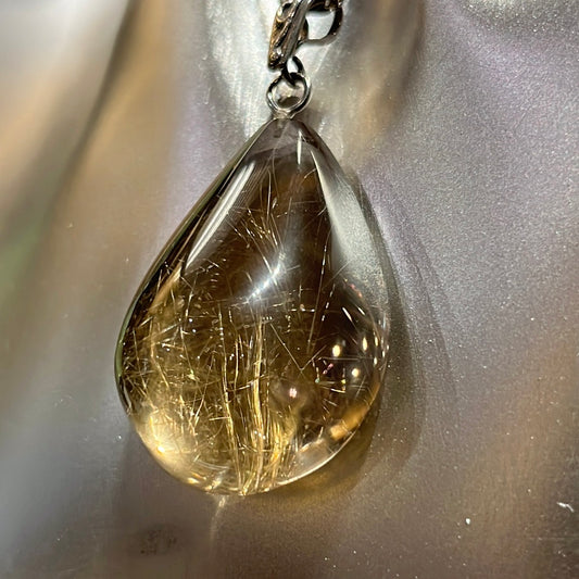 Teardrop-shaped Rutilated Quartz Pendant on silver chain. This unique piece of jewelry is authentic Alaska Native art created by an enrolled member of an Alaska Native tribe. 