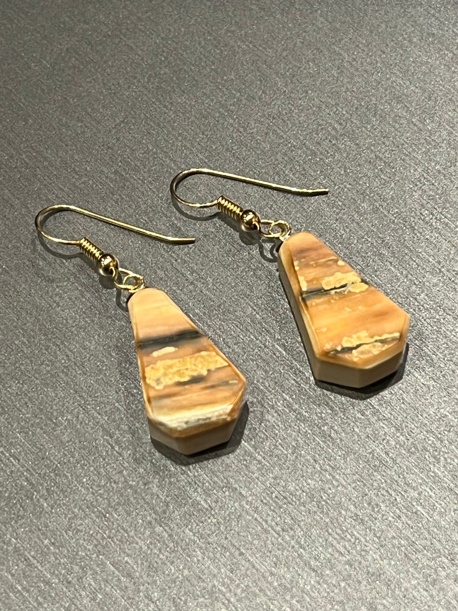 Reversible mammoth ivory earrings in 14k gold. This unique piece of jewelry is authentic Alaska Native art created by an enrolled member of an Alaska Native tribe. Certified Silver Hand and Made in Alaska jewelry.