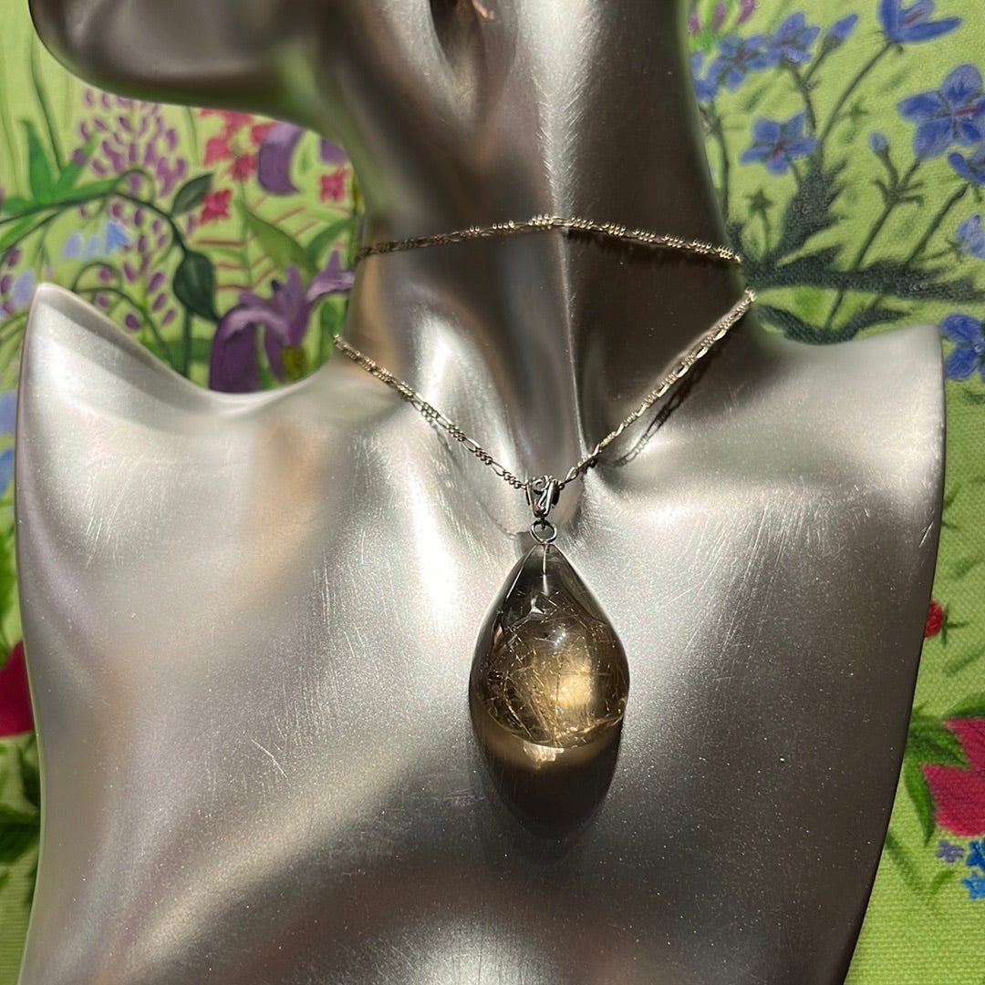 Teardrop-shaped Rutilated Quartz Pendant on silver chain. This unique piece of jewelry is authentic Alaska Native art created by an enrolled member of an Alaska Native tribe. 