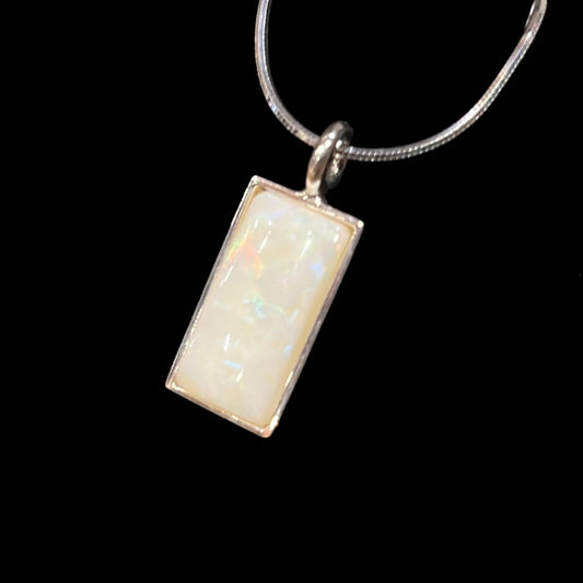 Rectangular 8.79 carat White Opal pendant in sterling on snake chain. This unique piece of jewelry is authentic Alaska Native art created by an enrolled member of an Alaska Native tribe.