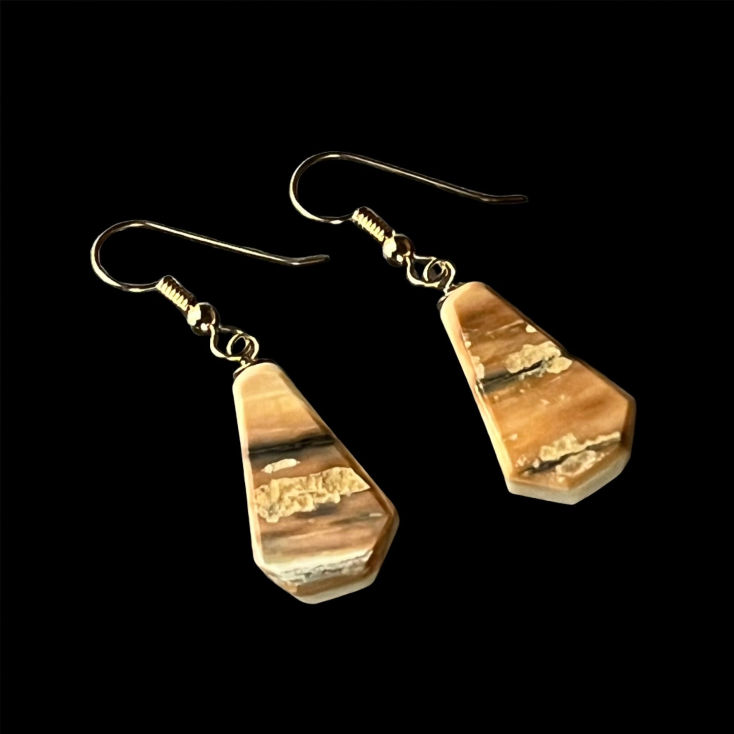 Reversible mammoth ivory earrings in 14k gold. This unique piece of jewelry is authentic Alaska Native art created by an enrolled member of an Alaska Native tribe. Certified Silver Hand and Made in Alaska jewelry.