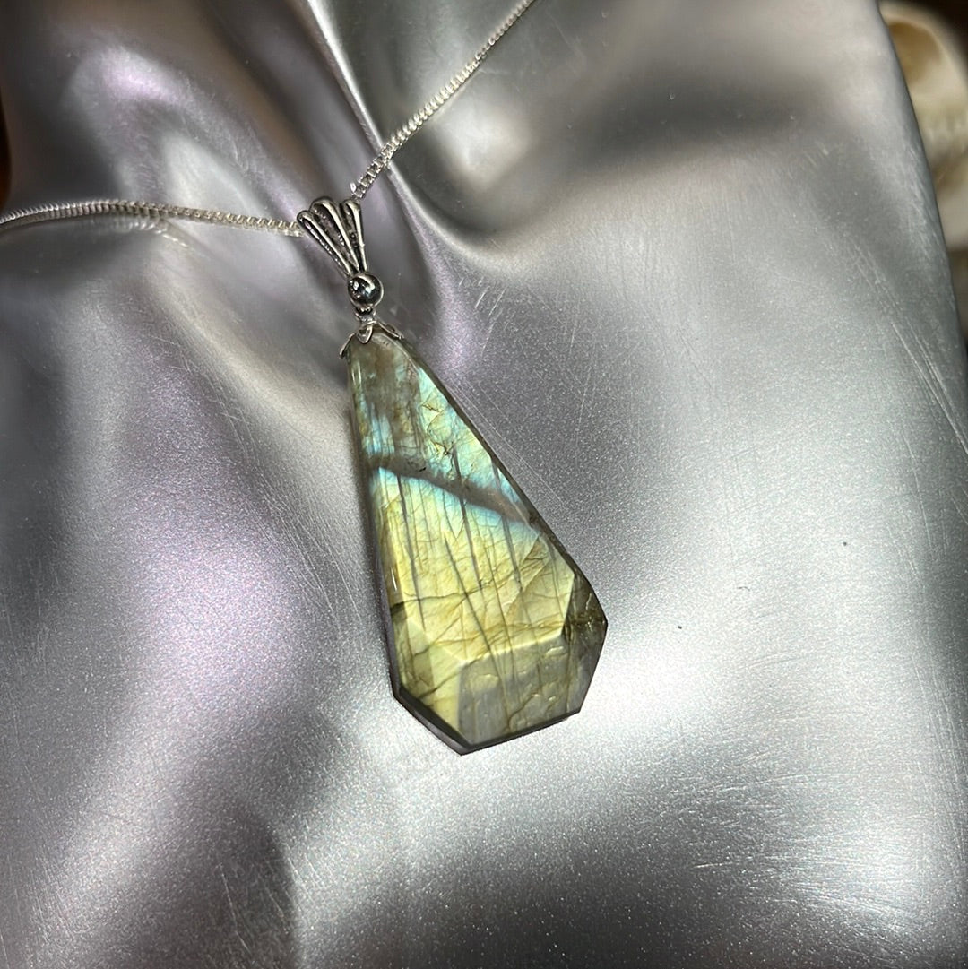 Modified teardrop labradorite pendant in silver. This unique piece of jewelry is authentic Alaska Native art created by an enrolled member of an Alaska Native tribe. 