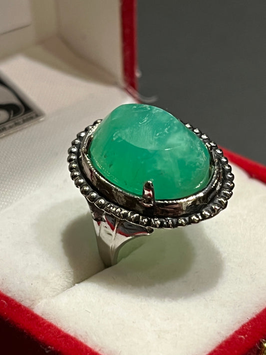 Bright green Chrysoprase set in an antique silver ring setting. This unique piece of jewelry is authentic Alaska Native art created by an enrolled member of an Alaska Native tribe. Certified Silver Hand and Made in Alaska jewelry.