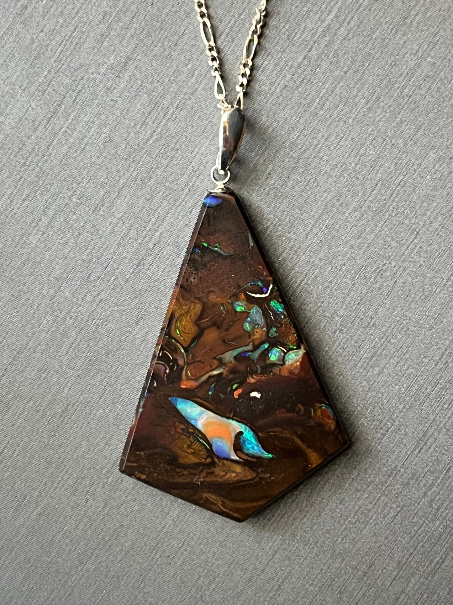 Australian Korite Opal pendant on silver, cut to maximize the beauty of the veins. This unique piece of jewelry is authentic Alaska Native art created by an enrolled member of an Alaska Native tribe. Certified Silver Hand and Made in Alaska jewelry.