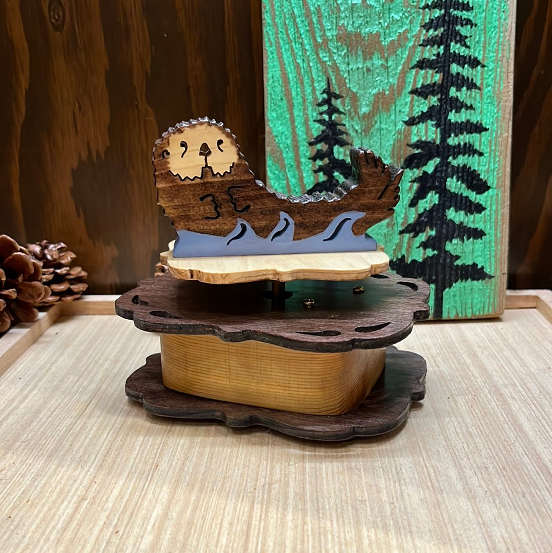 Wooden otter music box, hand scroll sawed, plays "You Light Up My Life".