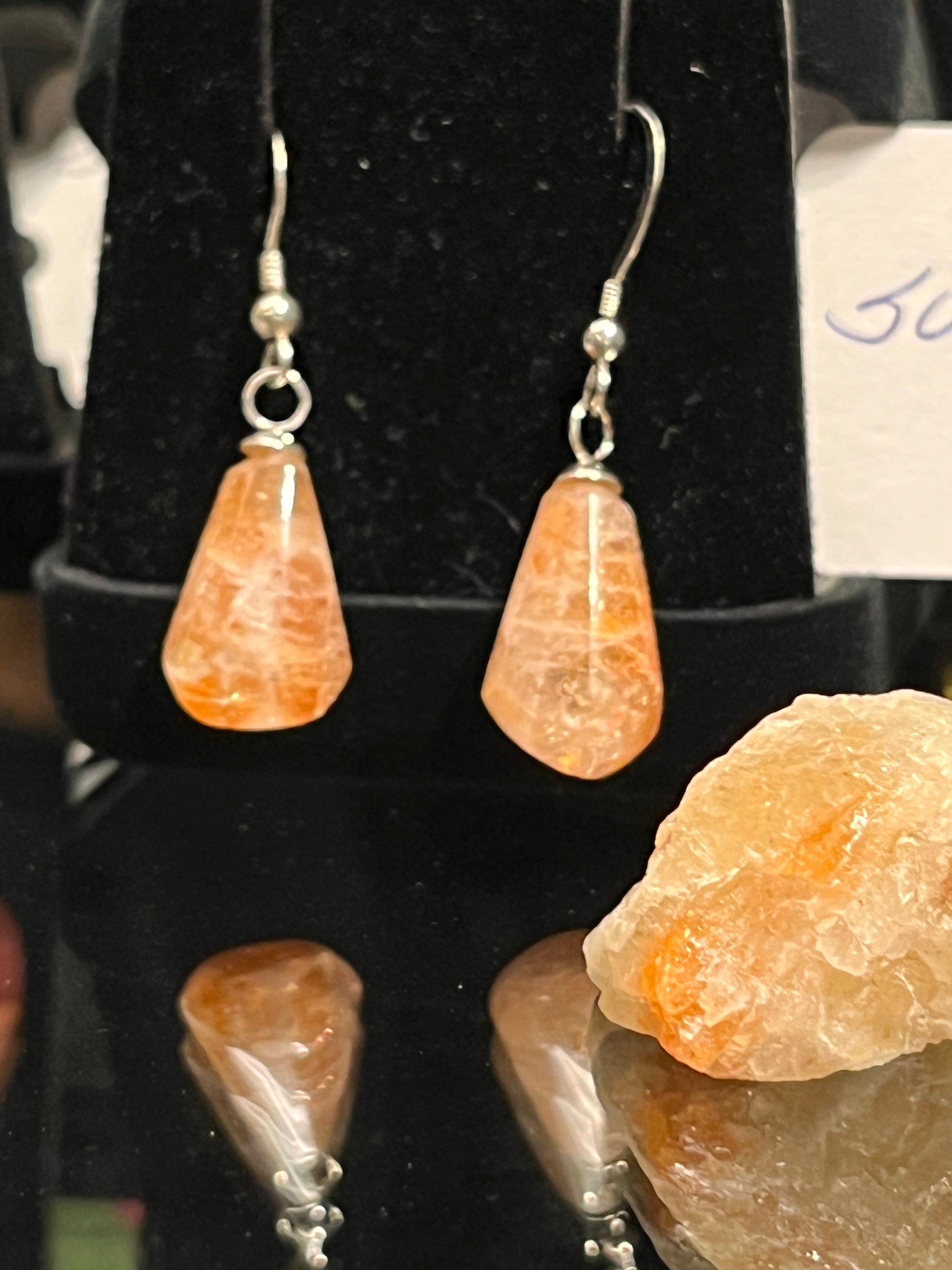 Pear-shaped sunstone earrings on silver. This unique piece of jewelry is authentic Alaska Native art created by an enrolled member of an Alaska Native tribe and is a certified Made in Alaska item. 
