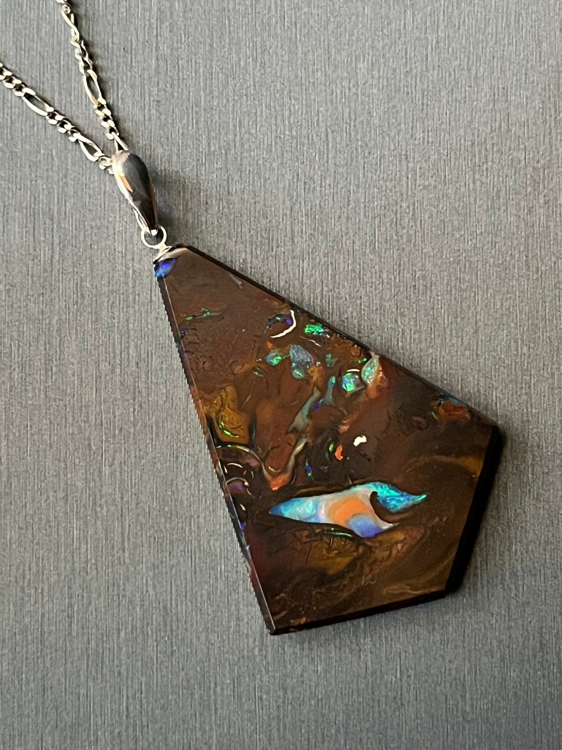 Australian Korite Opal pendant on silver, cut to maximize the beauty of the veins. This unique piece of jewelry is authentic Alaska Native art created by an enrolled member of an Alaska Native tribe. Certified Silver Hand and Made in Alaska jewelry.