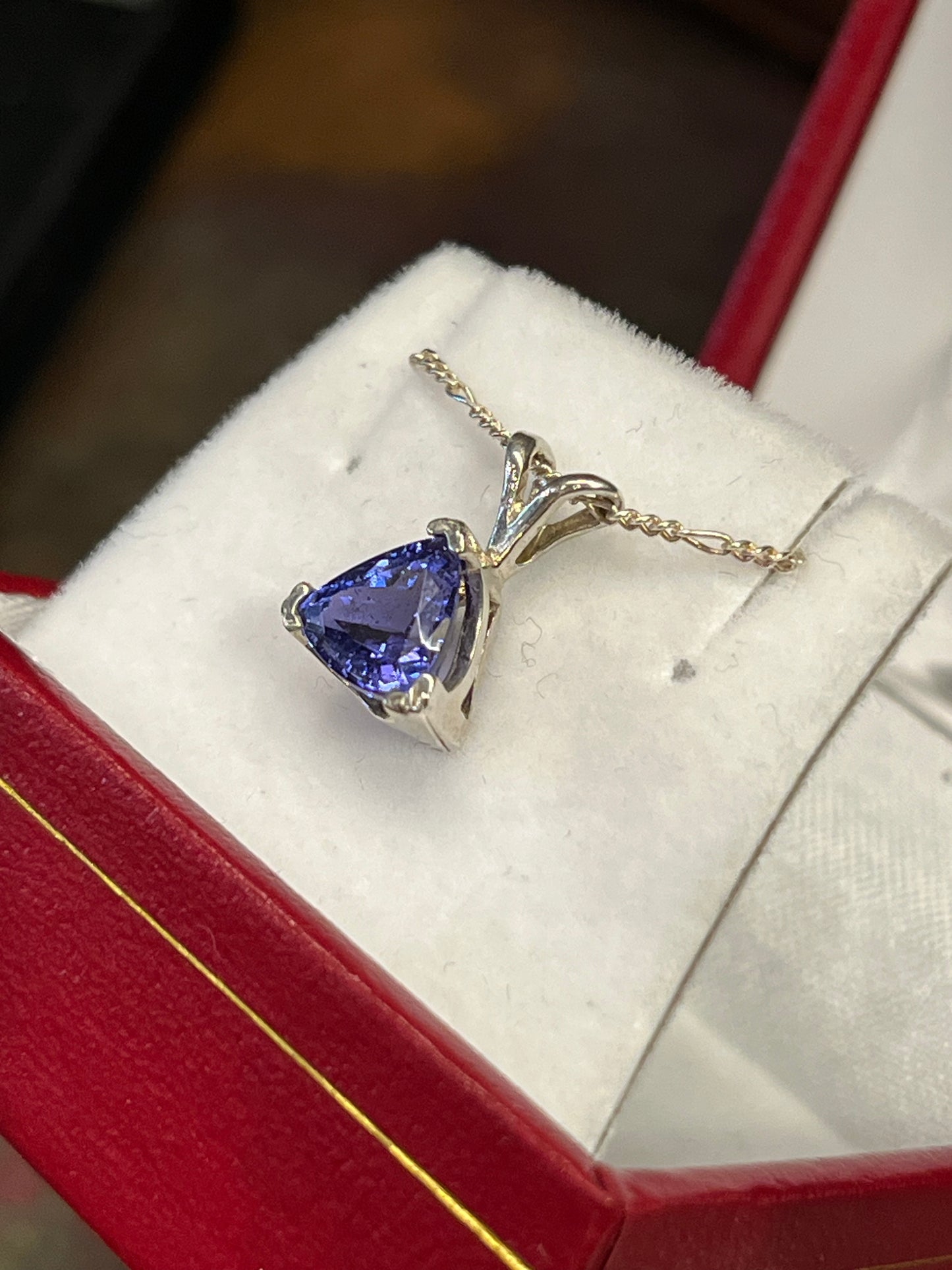 Triangular 1.42 carat Tanzanite pendant in silver. This rare gemstone is a birthstone of December, and is a traditional 24th anniversary gift. This unique piece of jewelry is authentic Alaska Native art created by an enrolled member of an Alaska Native tribe. Certified Silver Hand and Made in Alaska jewelry.