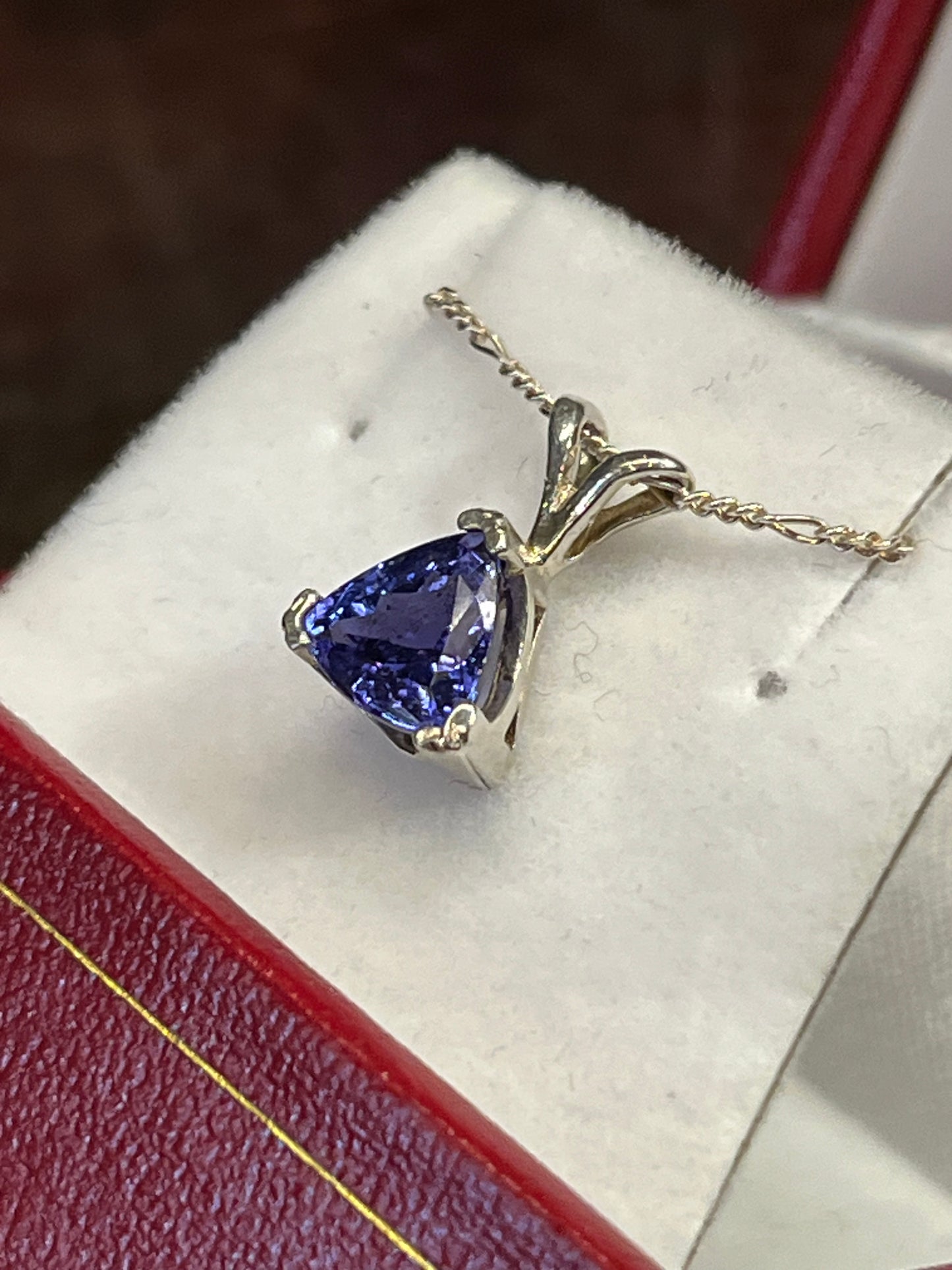 Triangular 1.42 carat Tanzanite pendant in silver. This rare gemstone is a birthstone of December, and is a traditional 24th anniversary gift. This unique piece of jewelry is authentic Alaska Native art created by an enrolled member of an Alaska Native tribe. Certified Silver Hand and Made in Alaska jewelry.